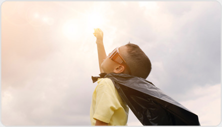 feature graphic: A child in a superhero costume reaching for the sun